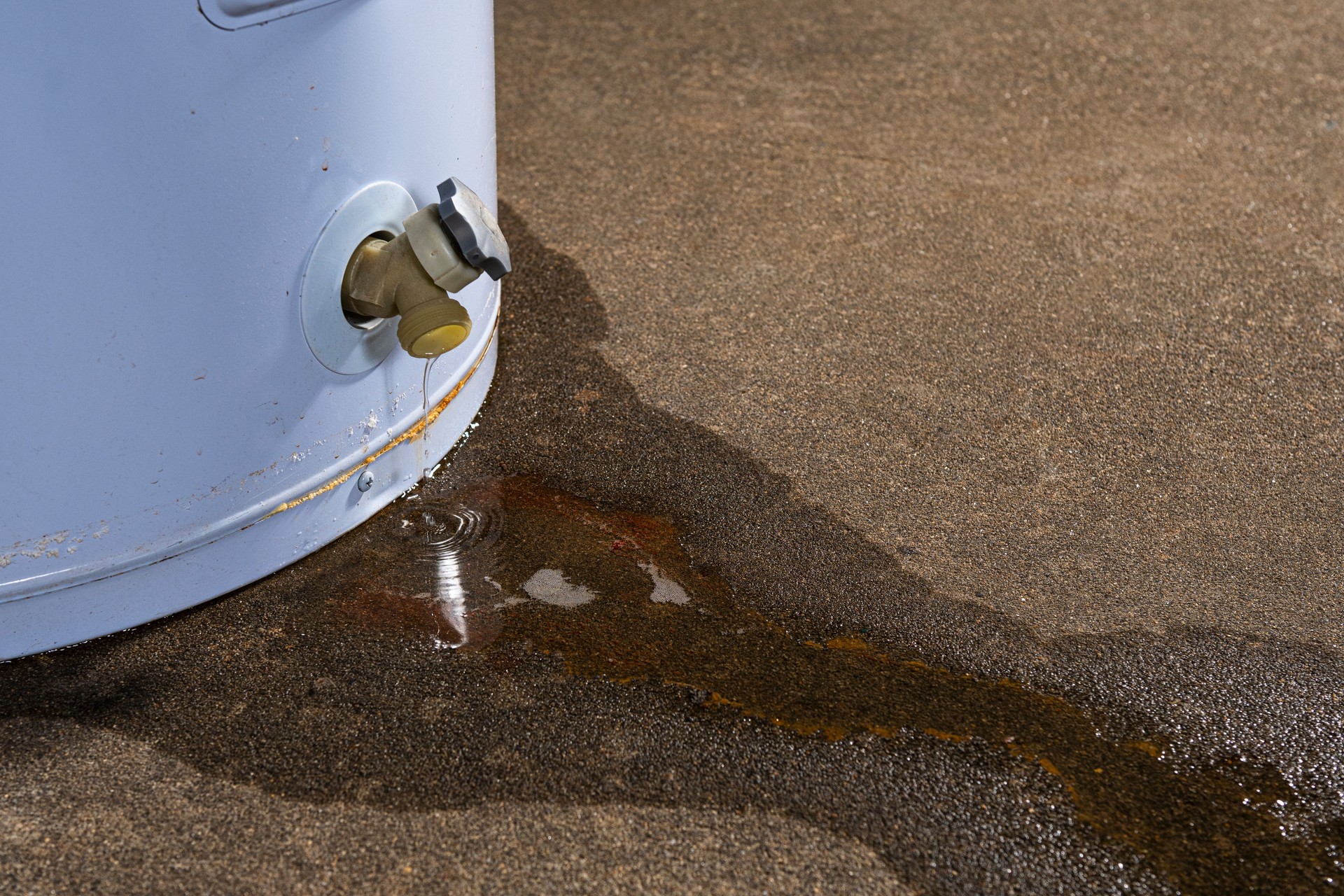 Nahaufnahme eines undichten Wasserhahns an einem Warmwasserbereiter